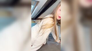 Blond leans forward slow with her top slipping off one shoulder