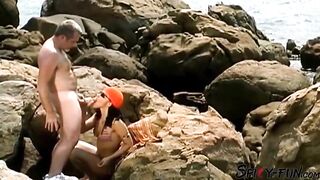 A female tourist receives a facial during the time that on rocks.