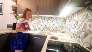 Sexy tiny real college beauty in a plaid school uniform mini petticoat flashes her legs and cotton pants in the kitchen