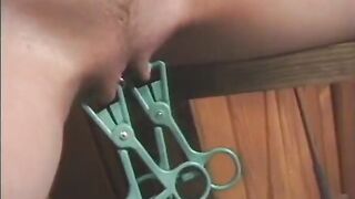 The impudent mistress makes her slave lick her boots and hangs clothespins on her intimate places