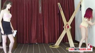 2 Pretty ladies play a game of strip darts