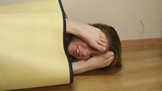 Two girls rub their feet on their faces