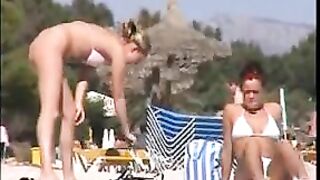 Two topless lesbian girls on the beach