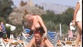 Two topless lesbian girls on the beach