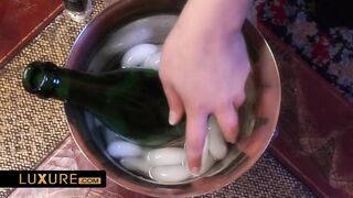 Two gorgeous and busty babes use a Champagne bottle as a sextoy