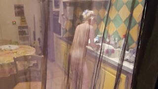 She's in the kitchen naked and she doesn't know I'm recording her and when that kinky bitch notices it turns her on