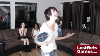 Three friends and one lucky guy playing a strip game in the living room