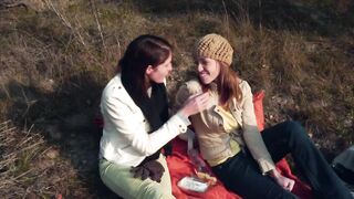 Horny brunette fucks her girl with strap on during a pic nic