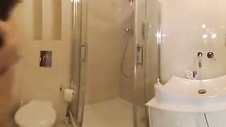 Two nude ladies are making love in the shower