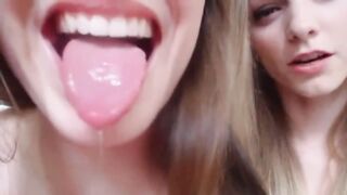 Sisters playing with spit