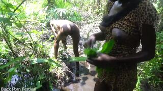 2 African tribe girl having fun with the village chief in the middle of the forrest