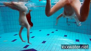 Milana and Katrin strip eachother underwater