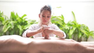 A small Asian woman massages a big penis