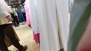 A girl walks in a short skirt without panties in a shopping mall