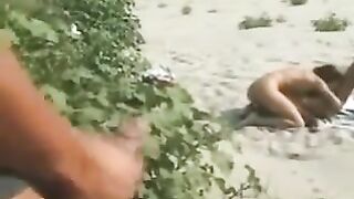 Italian lesbian couple fingering on the beach for voyeurs