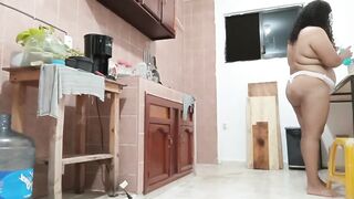 Overweight cutie in a belt cooking