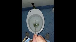 a youthful stud went into a messy public throne-room to pee and stroke