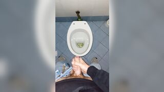 a youthful stud went into a messy public throne-room to pee and stroke