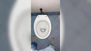 a youthful stud went into a messy public throne-room to pee and stroke
