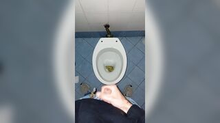 a youthful stud went into a messy public throne-room to pee and stroke