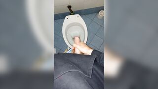 a youthful stud went into a messy public throne-room to pee and stroke