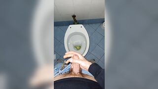a youthful stud went into a messy public throne-room to pee and stroke