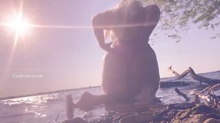 Bikini ass teasing in the water at a public beach!