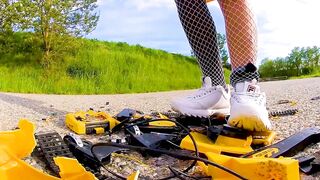 Large excavator is destroyed kicked, trampled, crushed, smashed, crushed, broken plastic car, crush