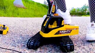 Large excavator is destroyed kicked, trampled, crushed, smashed, crushed, broken plastic car, crush