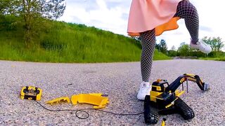 Large excavator is destroyed kicked, trampled, crushed, smashed, crushed, broken plastic car, crush