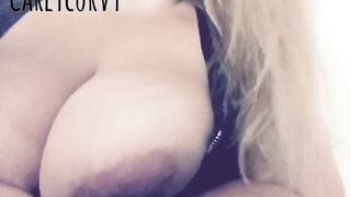 Blond Carlycurvy vaping and playing in a short leather costume