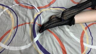 Caressing lengthy legs of angel in ebony lace socks