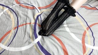 Caressing lengthy legs of angel in ebony lace socks