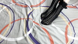 Caressing lengthy legs of angel in ebony lace socks