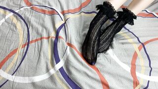 Caressing lengthy legs of angel in ebony lace socks