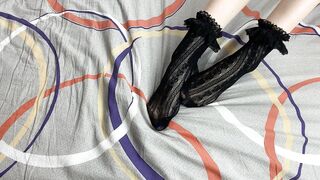 Caressing lengthy legs of angel in ebony lace socks