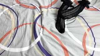 Caressing lengthy legs of angel in ebony lace socks