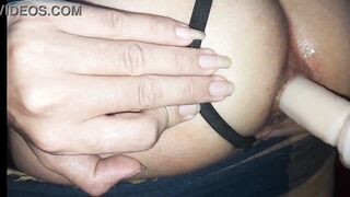 Floozy masturbates her butt with a sex toy.