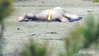 Mamma strips on the beach thinking that no one sees her
