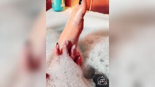 Sexy golden-haired massaging her soaked soapy feet in the baths