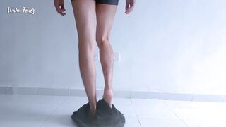 Lengthy legs and hot feet doing squats during the time that stripping