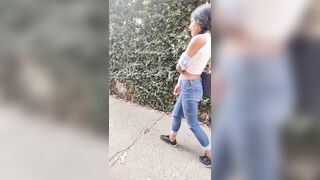 charming slim brunette hair is filmed by her boyfriend whilst this babe changes her blouse on the street