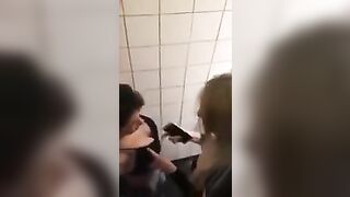 2 lesbians in a bar bathroom.