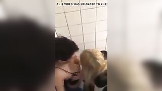 2 lesbians in a bar bathroom.