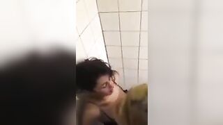2 lesbians in a bar bathroom.