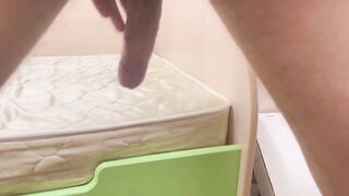 Stroking off in a crouch, arse to the camera. Fluid and cum leaks down.