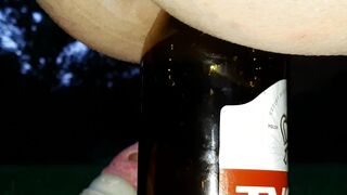 pissing and screwing a bottle in the park