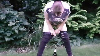 pissing and screwing a bottle in the park