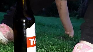 pissing and screwing a bottle in the park
