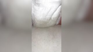 Chick fills up diaper with urinate until it overflows out the side